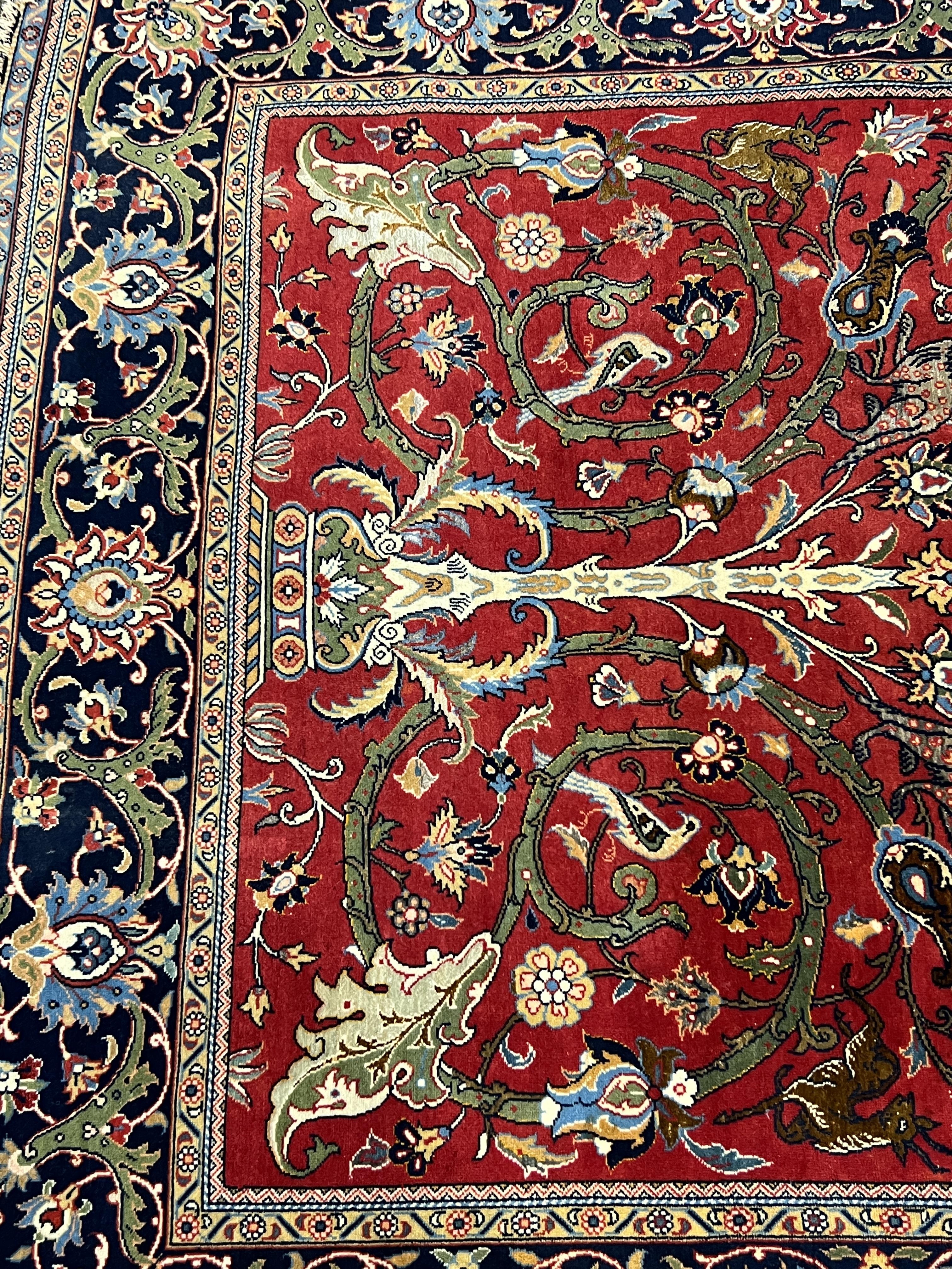 A Kashan red ground rug, woven with scrolling foliage and birds within a dark border, 216 x 138cm. Condition - good